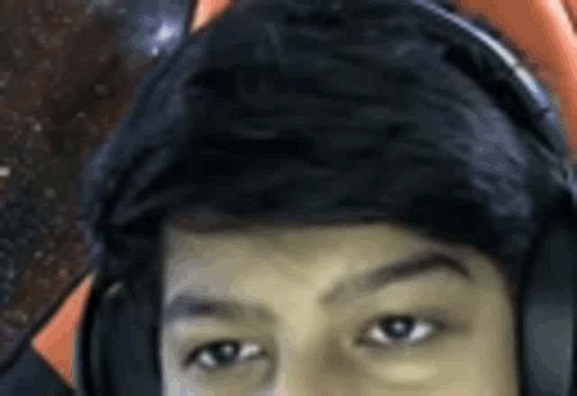 a close up of a person wearing headphones and a headset .