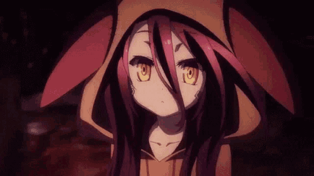 a girl with long red hair and yellow eyes is wearing a hooded jacket .