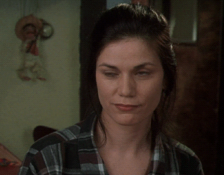 a woman wearing a plaid shirt is looking down