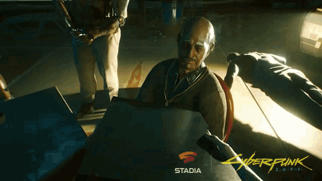 a man is holding a piece of paper in front of a stadia logo