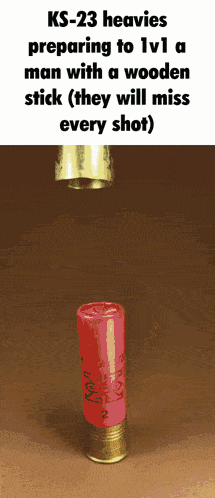 a red shotgun shell with a wooden stick on it