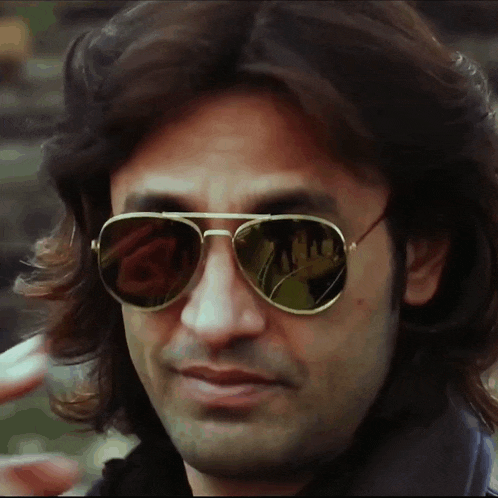 a close up of a man wearing a pair of sunglasses