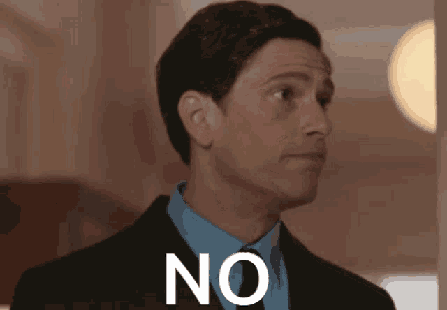 a man in a suit and tie has the word no on his face