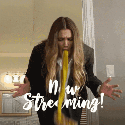 a woman in a suit is vomiting yellow liquid with the words now streaming written below her
