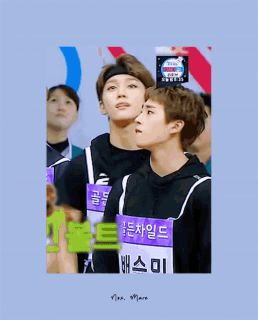 two young men wearing purple shirts with chinese writing on them