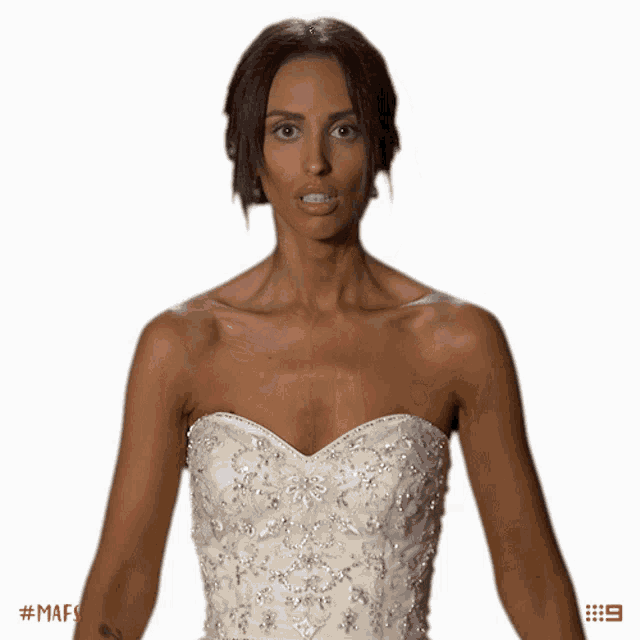 a woman in a white wedding dress with the number 9 on the bottom right