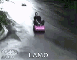 a man is riding a lawn mower down a road with the word lamo on the bottom .