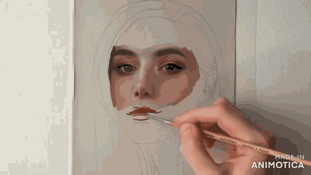 a person is painting a woman 's face with a brush that says made in animatica on the bottom