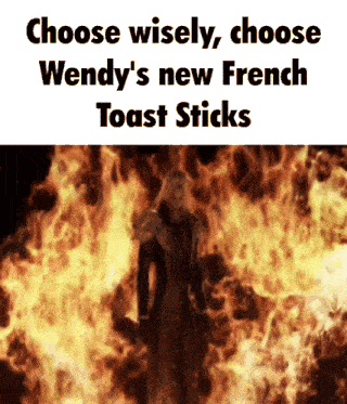 a man standing in front of a fire with the words choose wisely