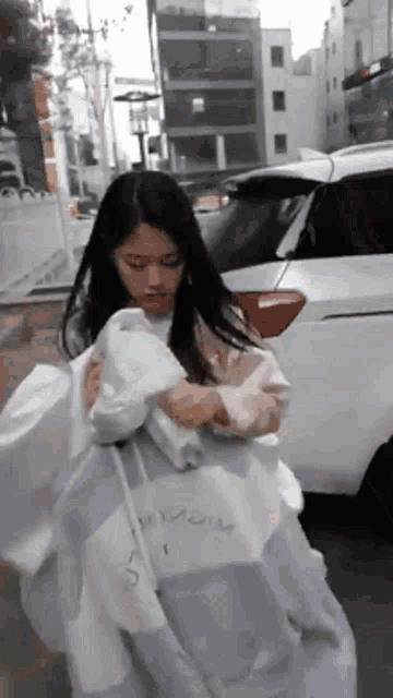 a woman wearing a purple and white sweatshirt with the word wow on it