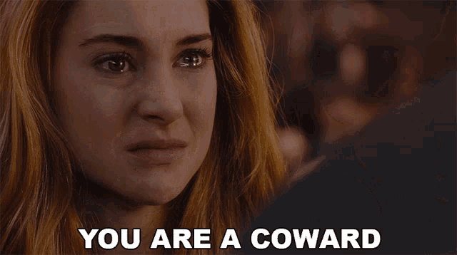 a woman with her mouth open and the words " you are a coward " behind her