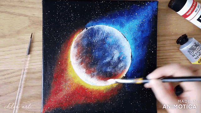 a person is painting a painting of a eclipse with a brush
