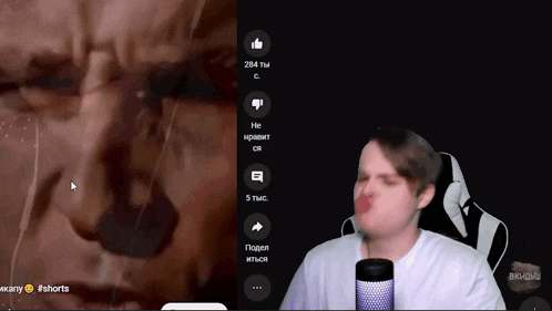 a man is making a funny face in front of a screen that says #shorts on it