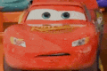 a close up of a red car with a cartoon face on it .