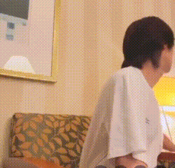 a man sitting in a chair with a towel on his shoulder