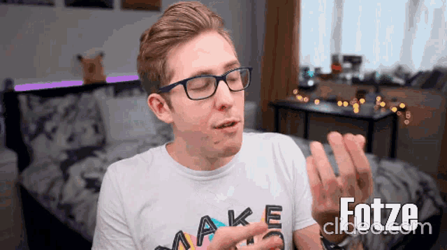 a man wearing glasses and a make t-shirt