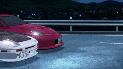 a red car with a license plate that says l3-137 is parked next to a white car