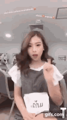 a young woman is sitting in a chair and making a funny face .