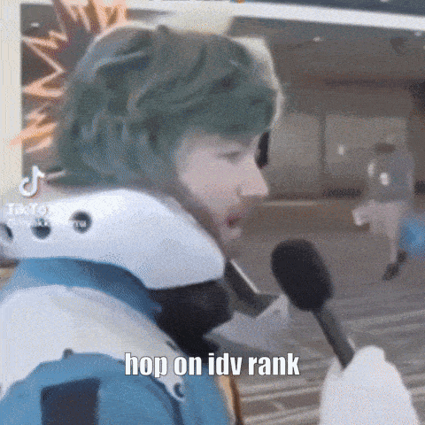 a person wearing a helmet is holding a microphone and saying hop on idv rank .