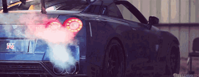 a blue sports car with the letter r on the side