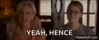 two women are sitting next to each other in a room and one of them is laughing .
