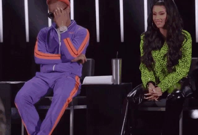 a man in a purple tracksuit sits next to a woman in a neon green leopard print shirt