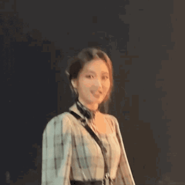 a blurry picture of a woman wearing headphones and a necklace .