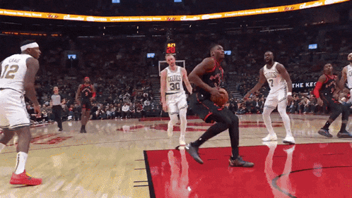 a basketball player wearing a number 30 jersey is dribbling the ball