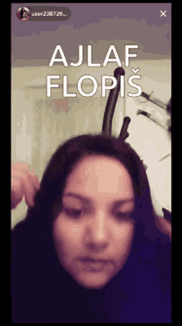 a woman 's face is shown with the words ajlaf flopis written above her