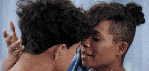 a man and a woman touching each other 's faces