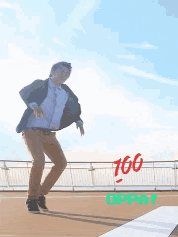 a man is dancing in front of a sign that says " 100 oppai "