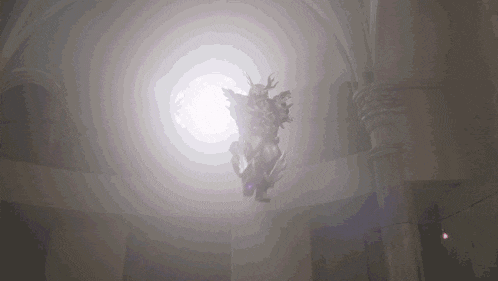 a statue of a man with horns is flying through the air in a dark room .