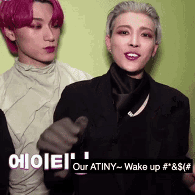 a man with pink hair is standing next to another man with gray hair