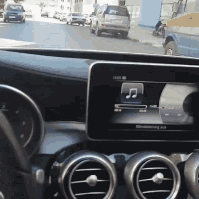 a car is driving down a street and the clock says 15:06
