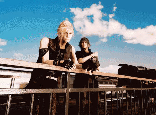 two men standing next to each other on a railing with a blue sky behind them