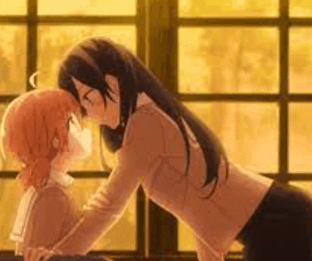 a couple of anime girls kissing each other in front of a window .