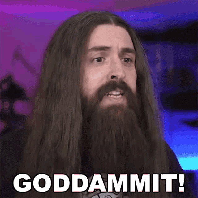 a man with long hair and a beard is making a face and says goddammit
