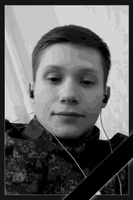 a black and white photo of a young man with headphones