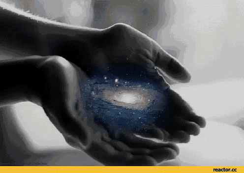 a black and white photo of a person holding a galaxy
