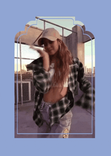 a woman wearing a plaid shirt and a hat that says nyc on it
