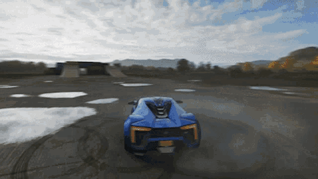 a blue sports car with a license plate that says ' yyj ' on it