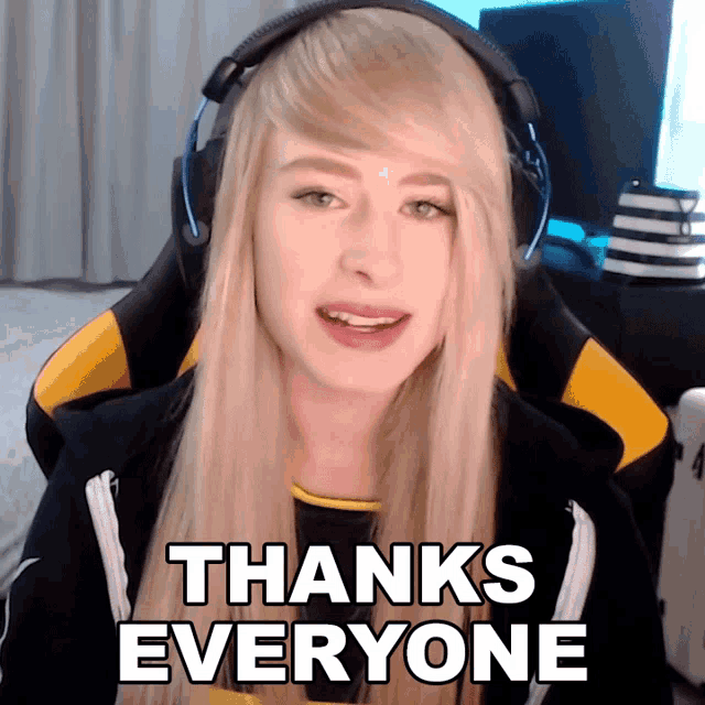 a woman wearing headphones and a hoodie says thanks everyone