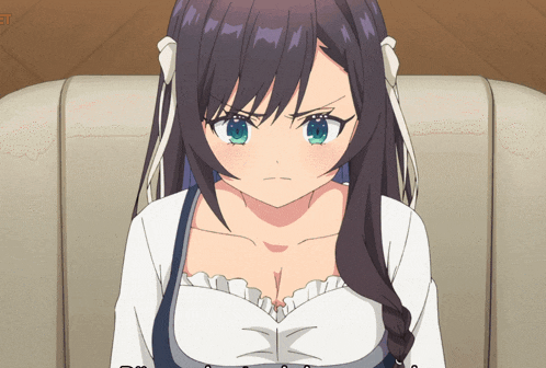 a girl with dark hair and green eyes is sitting on a chair