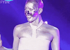 a person with silver paint on their face is standing in front of a purple background with fydr written on it