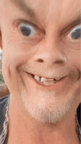 a man with a beard is making a funny face