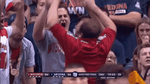 a basketball game is being played between wisconsin and arizona .