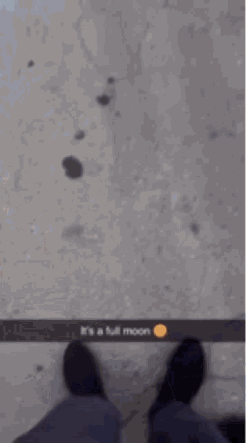 a blurry picture of a person walking on a sidewalk with a caption that says it 's a full moon