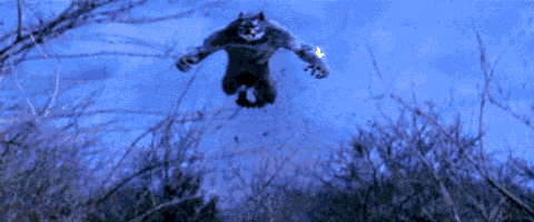a werewolf with its mouth open standing in the grass