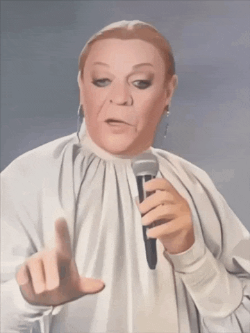 a woman in a white shirt is holding a microphone