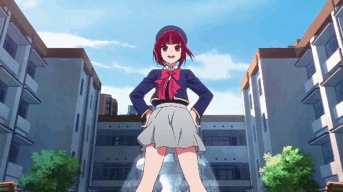 a girl with red hair is standing in front of buildings